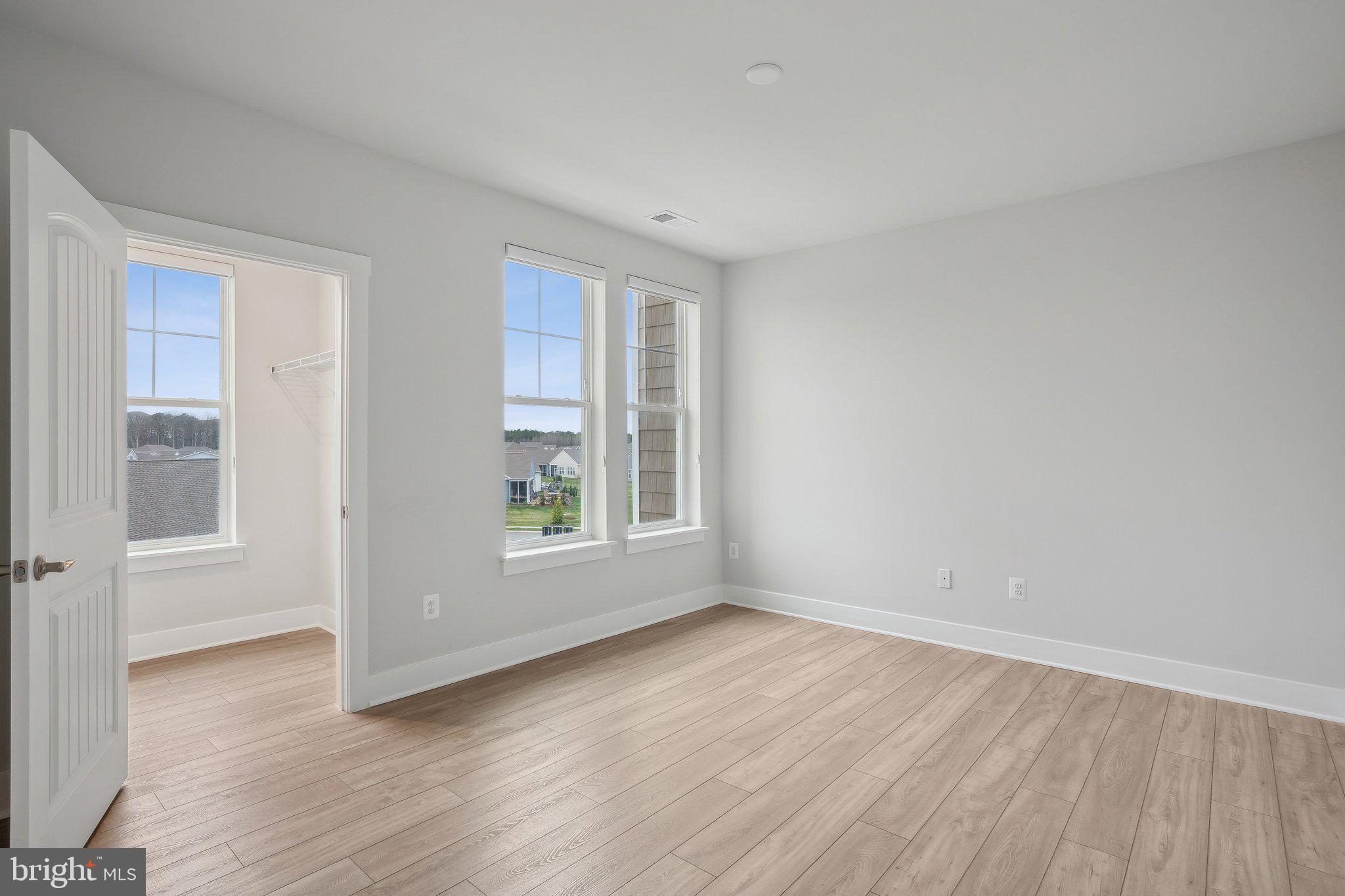 170 Harrier Way, Unit 34 Chester, MD 21619 - Photo 30 of 81 an empty room with wooden floor and windows