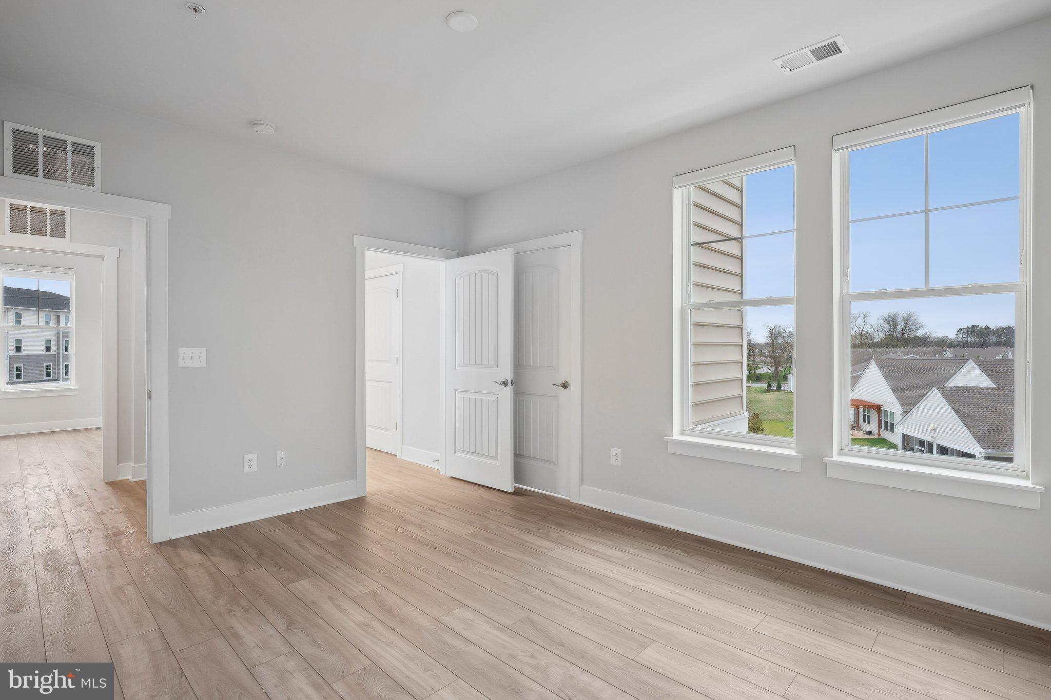 170 Harrier Way, Unit 34 Chester, MD 21619 - Photo 31 of 81 an empty room with wooden floor and windows