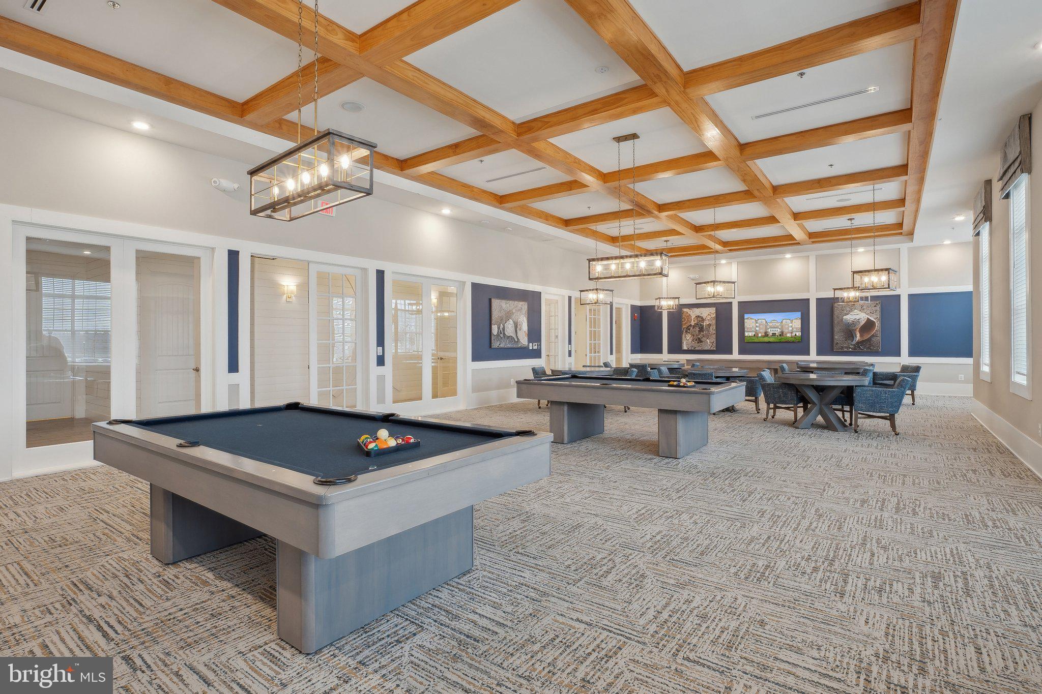 170 Harrier Way, Unit 34 Chester, MD 21619 - Photo 49 of 81 a living room with furniture a table tennis and air hockey table