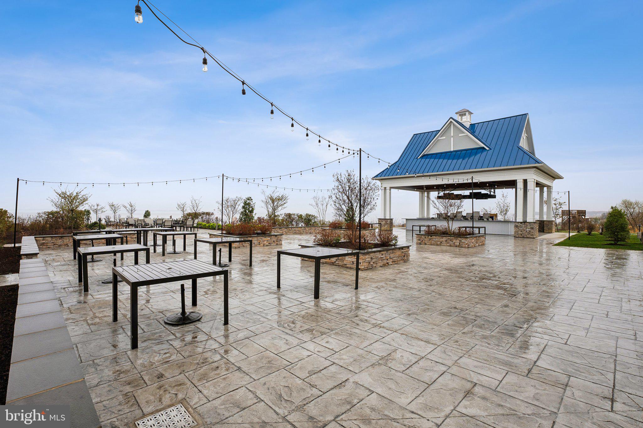170 Harrier Way, Unit 34 Chester, MD 21619 - Photo 57 of 81 a view of a patio with table and chairs with wooden floor and fence