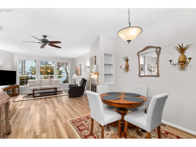 a living room with a table chairs and a dining table