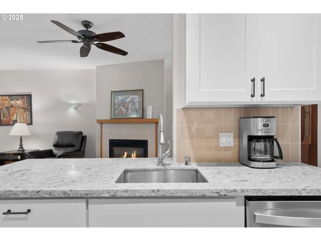 a view of living room with granite countertop furniture and a fireplace