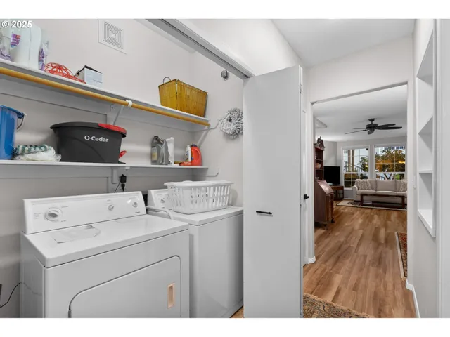 a view of washer and dryer with kitchen in the background