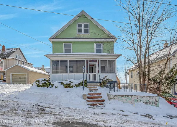 a front view of a house with sitting area