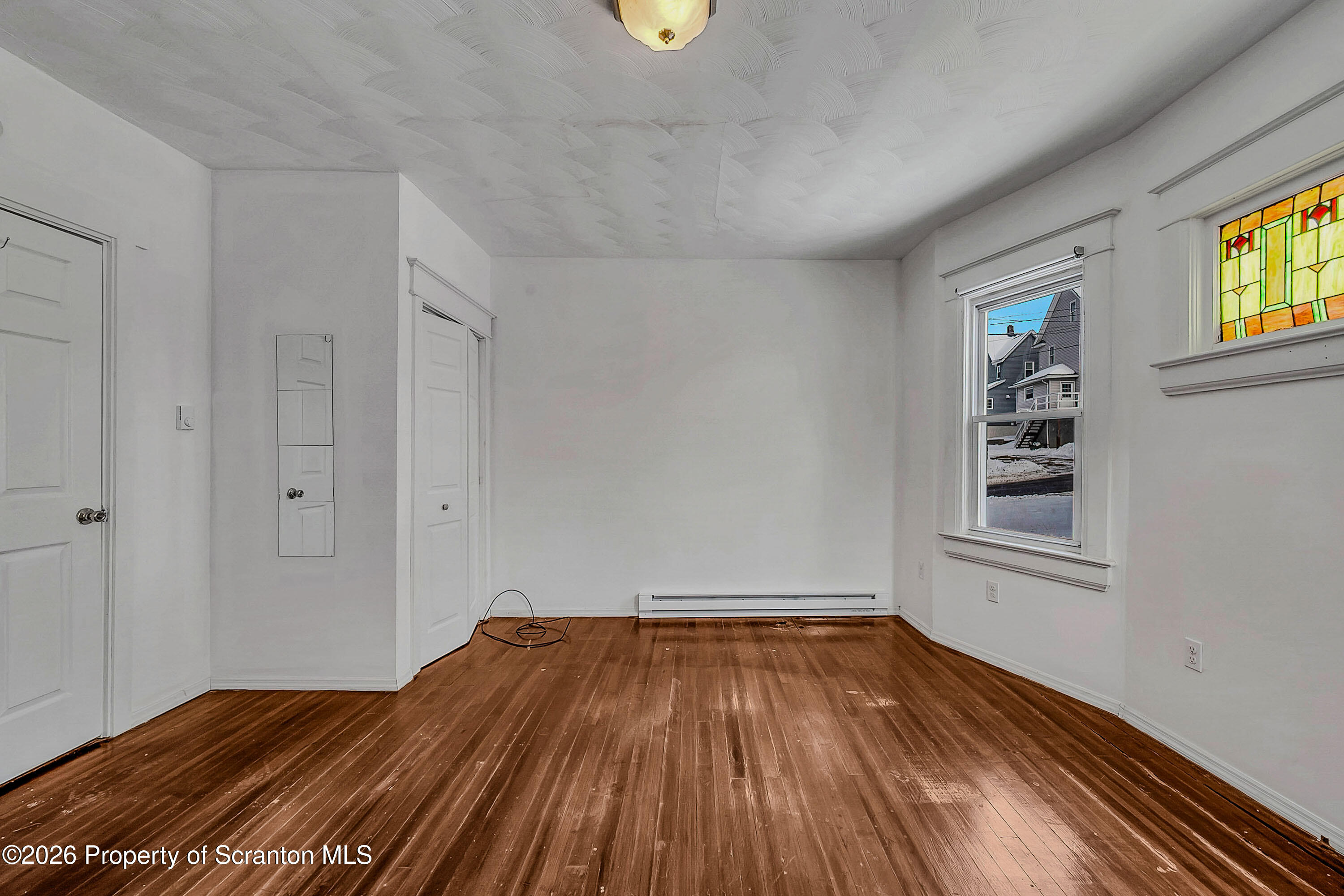 208 East Warren Street, Unit 1 Dunmore, PA 18512 - Photo 12 of 18 a view of empty room with wooden floor and fan