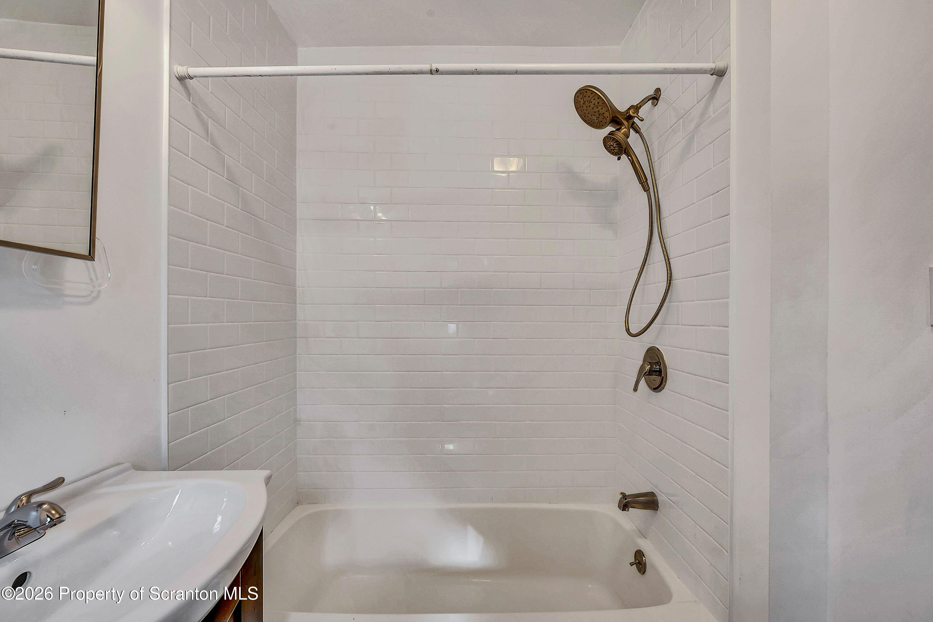 208 East Warren Street, Unit 1 Dunmore, PA 18512 - Photo 14 of 18 a bathroom with a bath tub with a shower