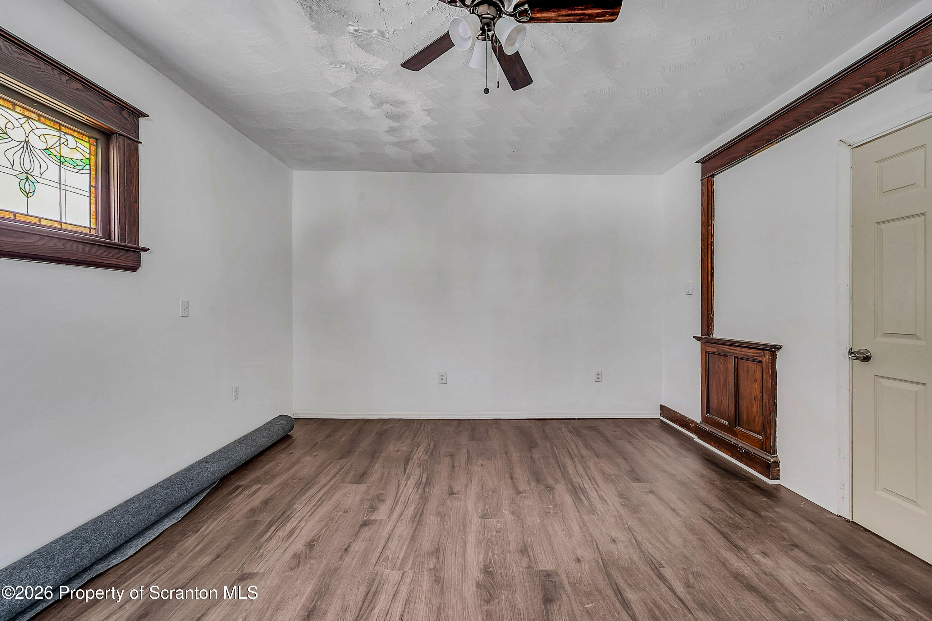 208 East Warren Street, Unit 1 Dunmore, PA 18512 - Photo 10 of 18 a view of a room with wooden floor fan and windows