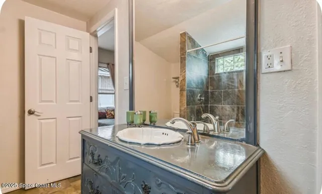 a bathroom with double vanity and a mirror