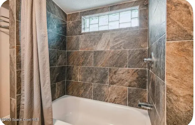 a bathroom with a tub and shower