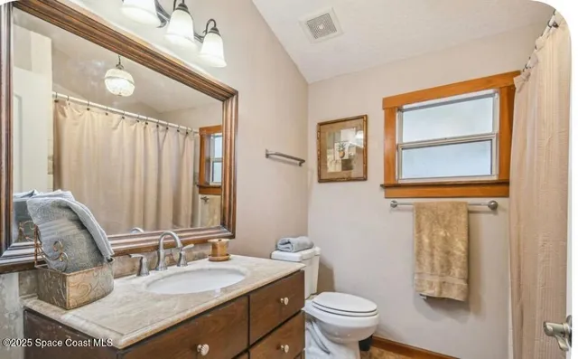 a bathroom with a sink vanity and a mirror