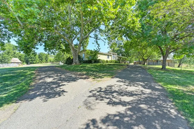 a kitchen with white cabinets and sink