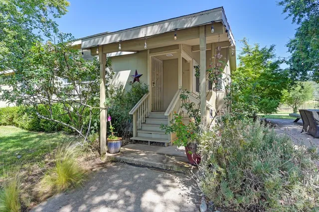 an empty room with a window and a ceiling fan
