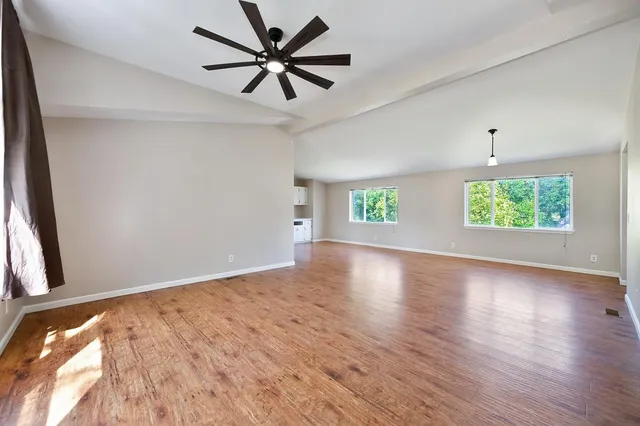 a view of a house with backyard and garden