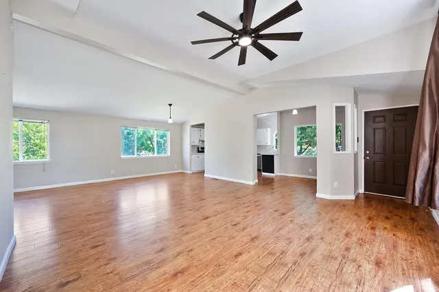 a view of a green field with trees in the background