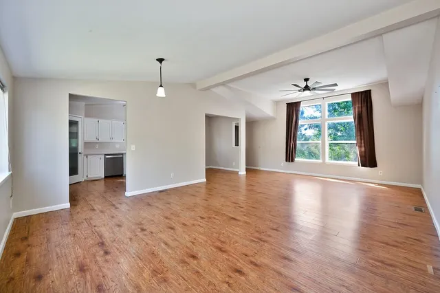 a backyard of a house with lots of green space and lake view