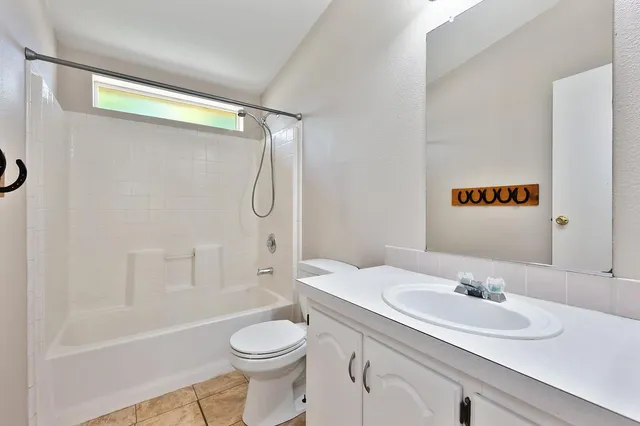 a view of a lush green forest with trees and some houses