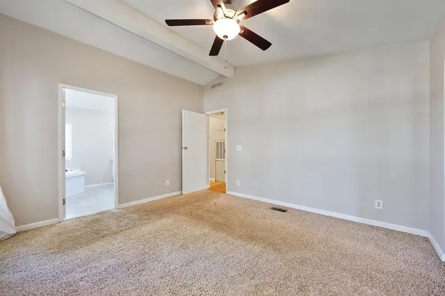 an aerial view of a houses with a lush green hillside