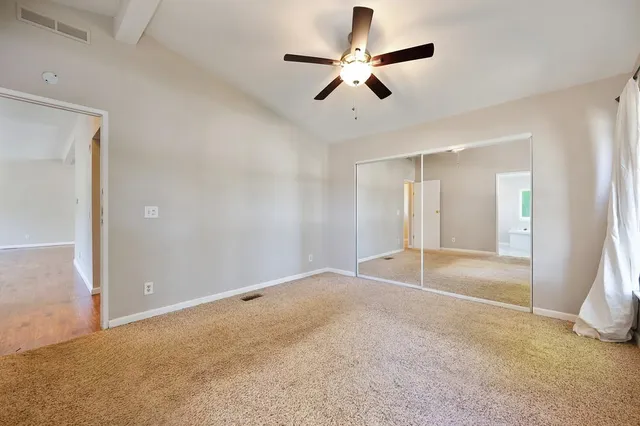 an aerial view of residential house with yard and mountain view in back