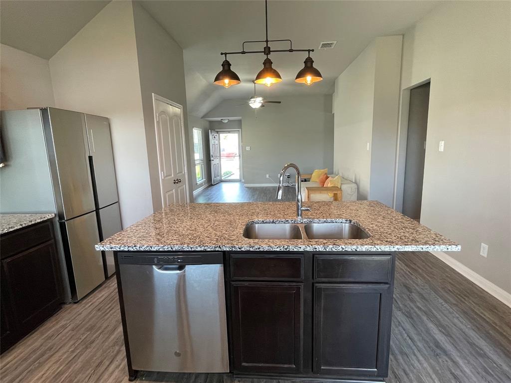 3920 South Fork Ranch Road Waco, TX 76705 - Photo 11 of 21 a kitchen with stainless steel appliances granite countertop a sink a refrigerator and wooden floor