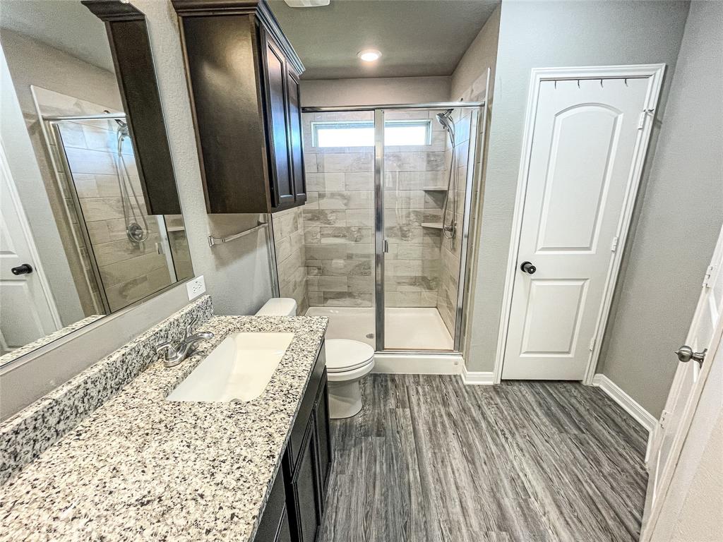 3920 South Fork Ranch Road Waco, TX 76705 - Photo 13 of 21 a bathroom with a granite countertop shower a sink and a mirror