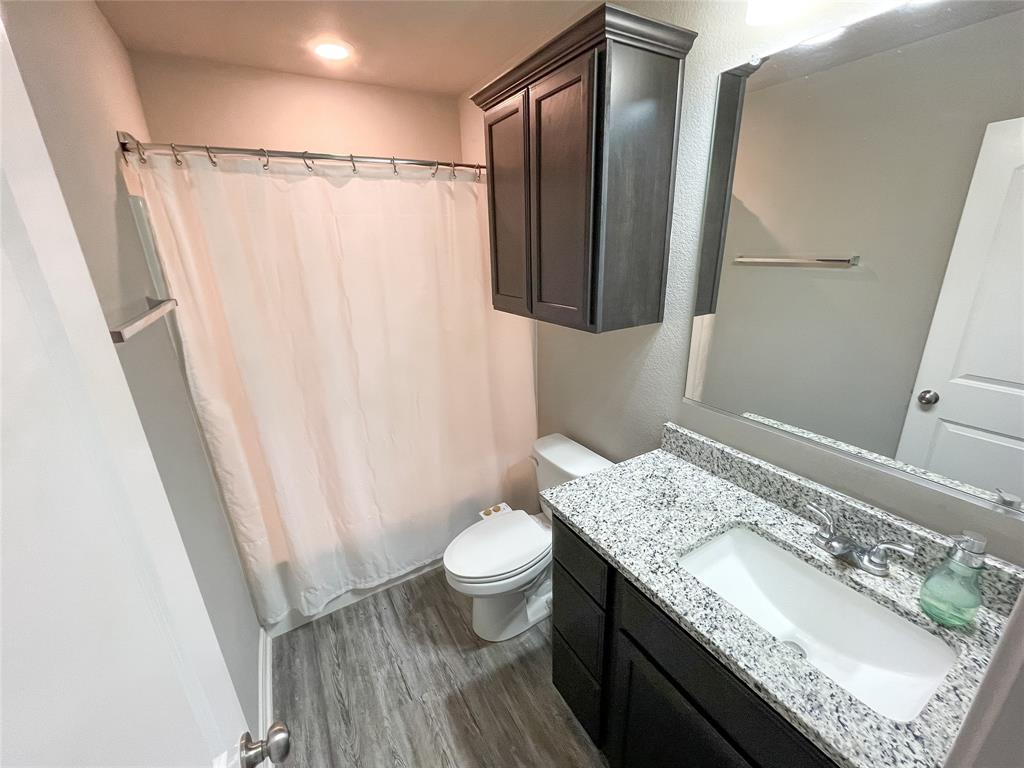 3920 South Fork Ranch Road Waco, TX 76705 - Photo 18 of 21 a bathroom with a granite countertop sink toilet and shower