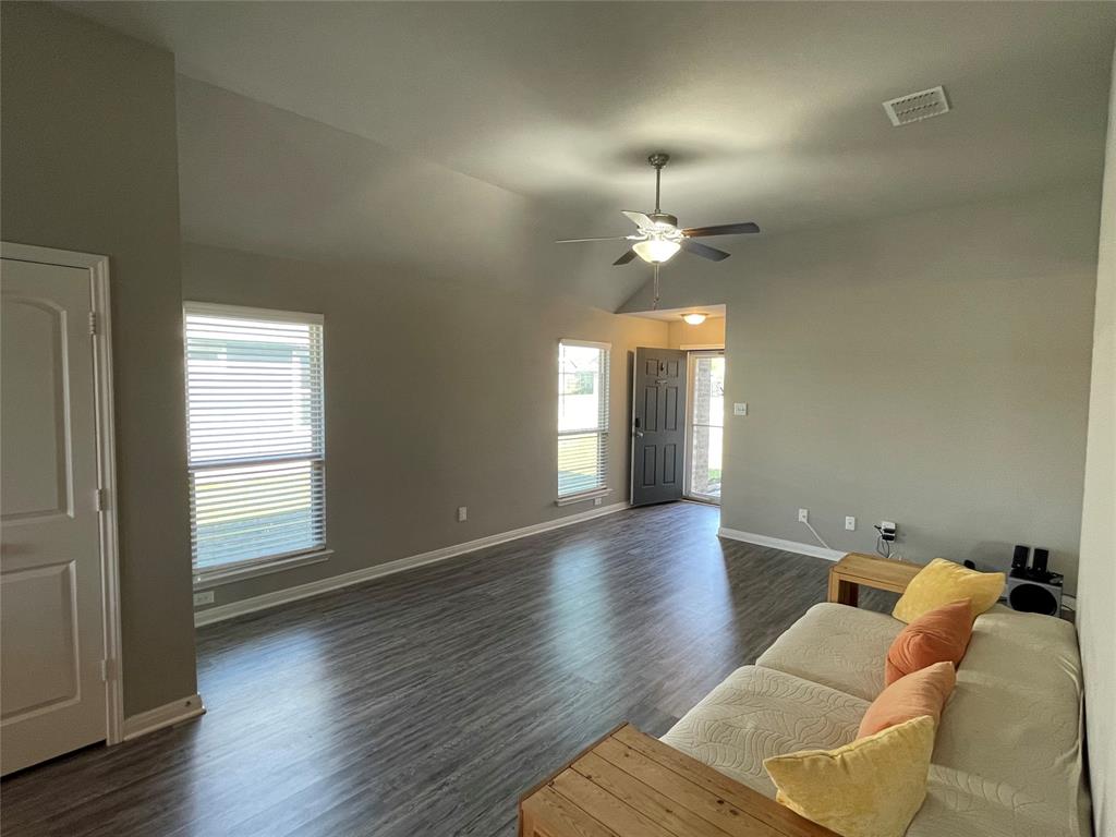 3920 South Fork Ranch Road Waco, TX 76705 - Photo 5 of 21 wooden floor in an empty room with a window
