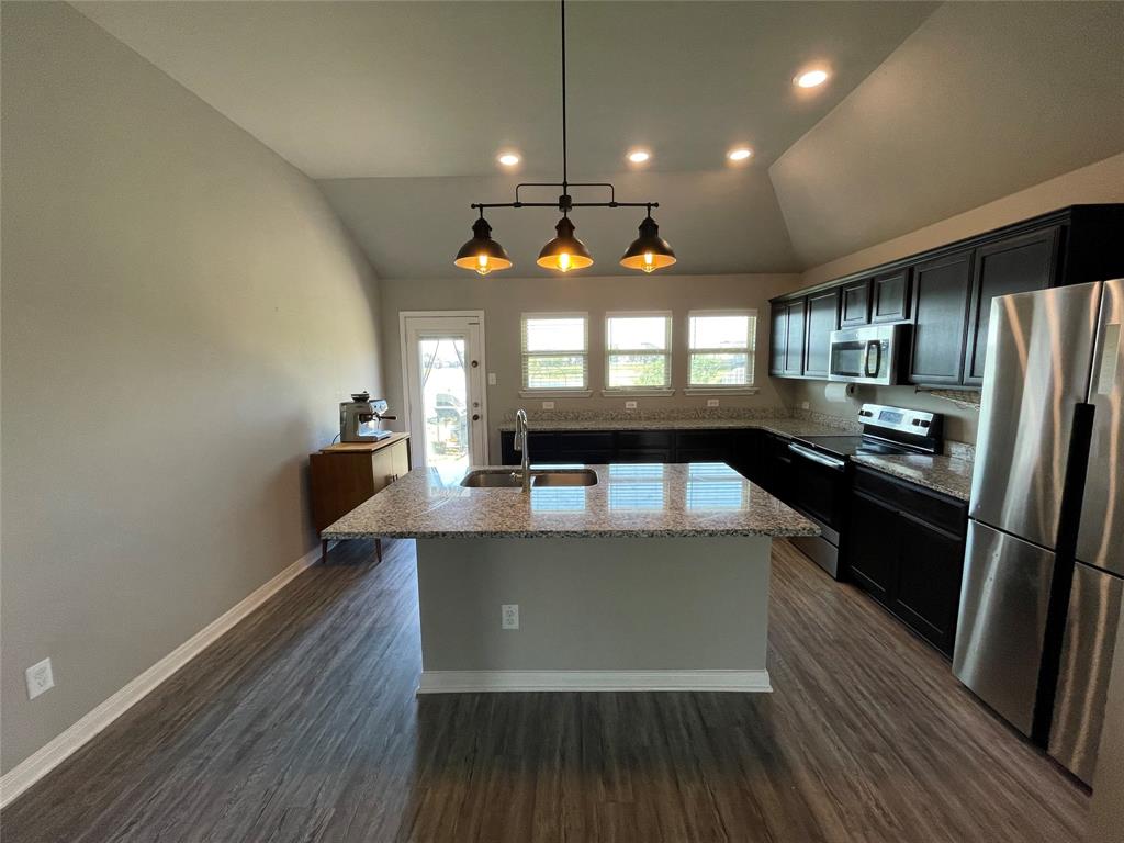 3920 South Fork Ranch Road Waco, TX 76705 - Photo 6 of 21 a view of a kitchen with kitchen island a counter space a sink and appliances