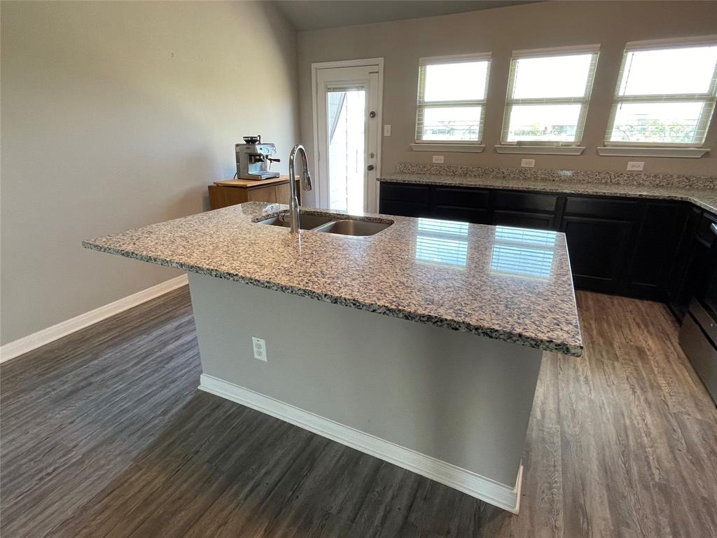 3920 South Fork Ranch Road Waco, TX 76705 - Photo 7 of 21 a kitchen with a sink a window and wooden floor