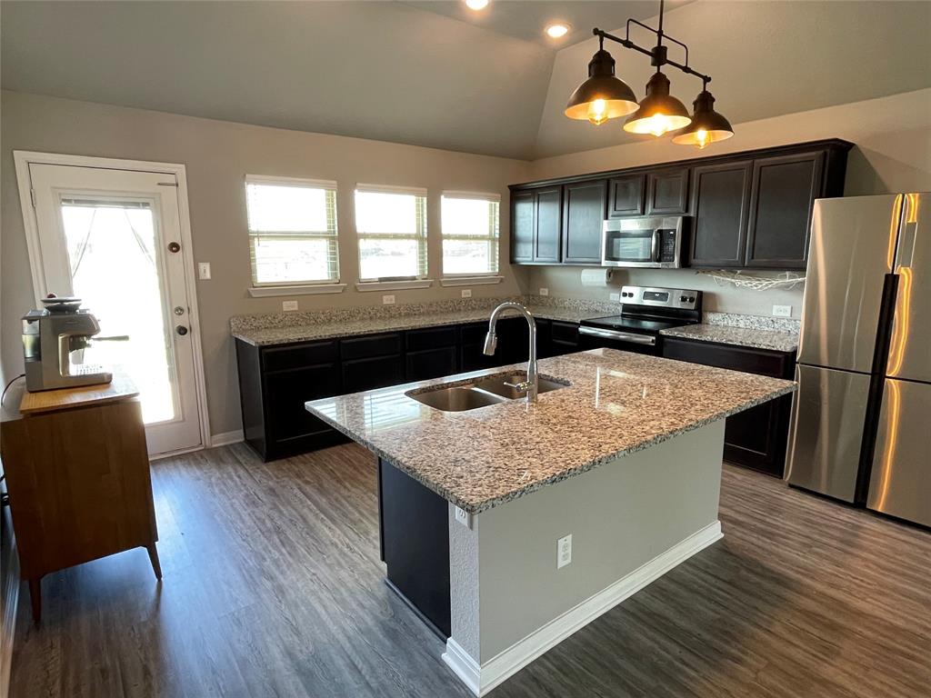 3920 South Fork Ranch Road Waco, TX 76705 - Photo 8 of 21 a kitchen with stainless steel appliances granite countertop a sink a stove and a refrigerator