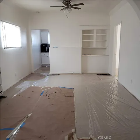 an empty room with closet and windows