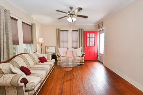 a living room with furniture and wooden floor