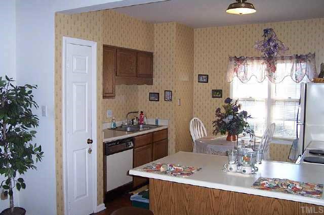 6151 Bushmills Street Raleigh, NC 27613 - Photo 3 of 10 a dining room with a table and chairs in it