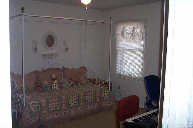 6151 Bushmills Street Raleigh, NC 27613 - Photo 9 of 10 a bed sitting in a room next to a window