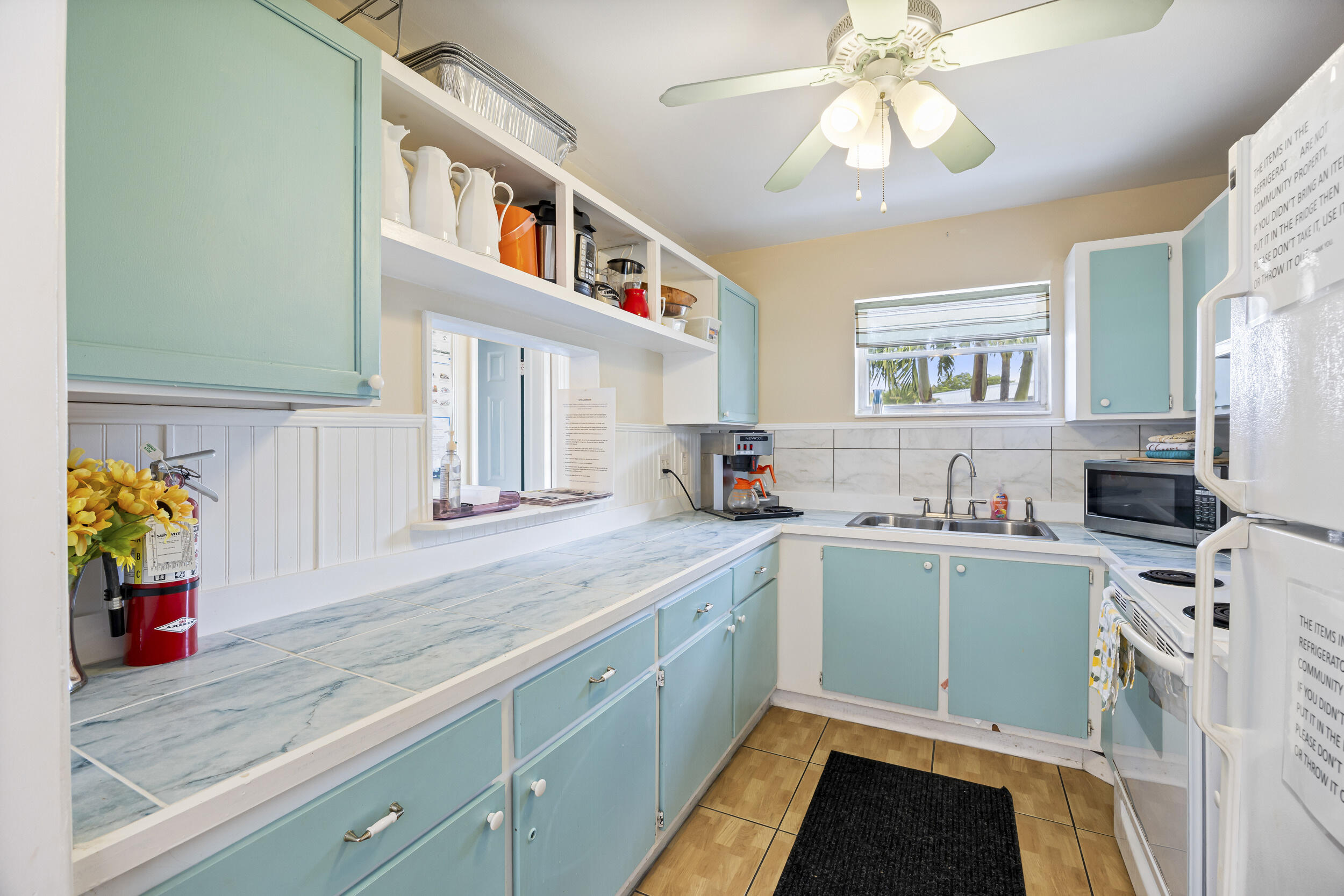 2929 Southeast Ocean Boulevard, Unit 10510 Stuart, FL 34996 - Photo 27 of 37 a kitchen with a sink cabinets and window