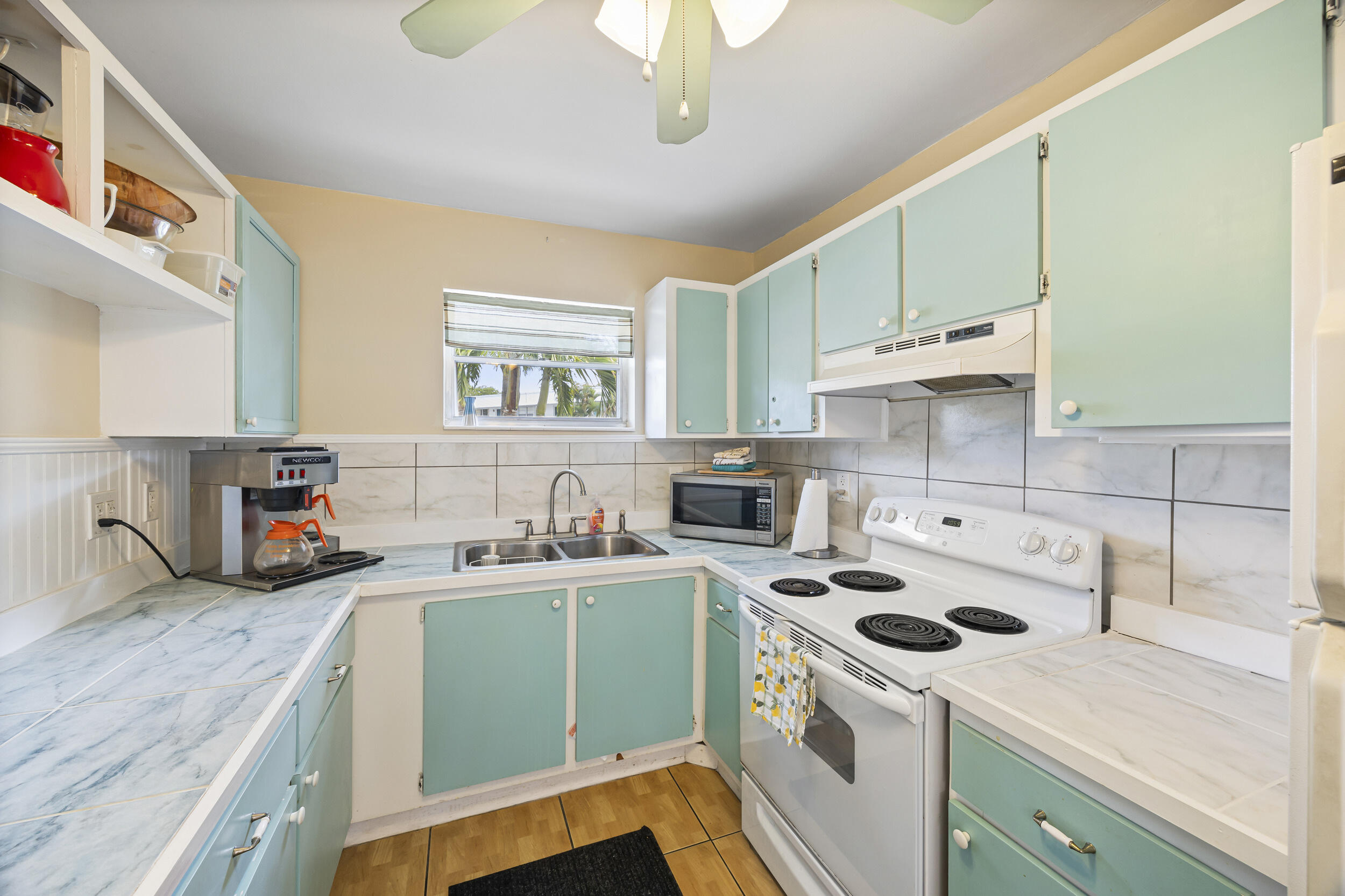 2929 Southeast Ocean Boulevard, Unit 10510 Stuart, FL 34996 - Photo 28 of 37 a kitchen with a sink a stove and cabinets
