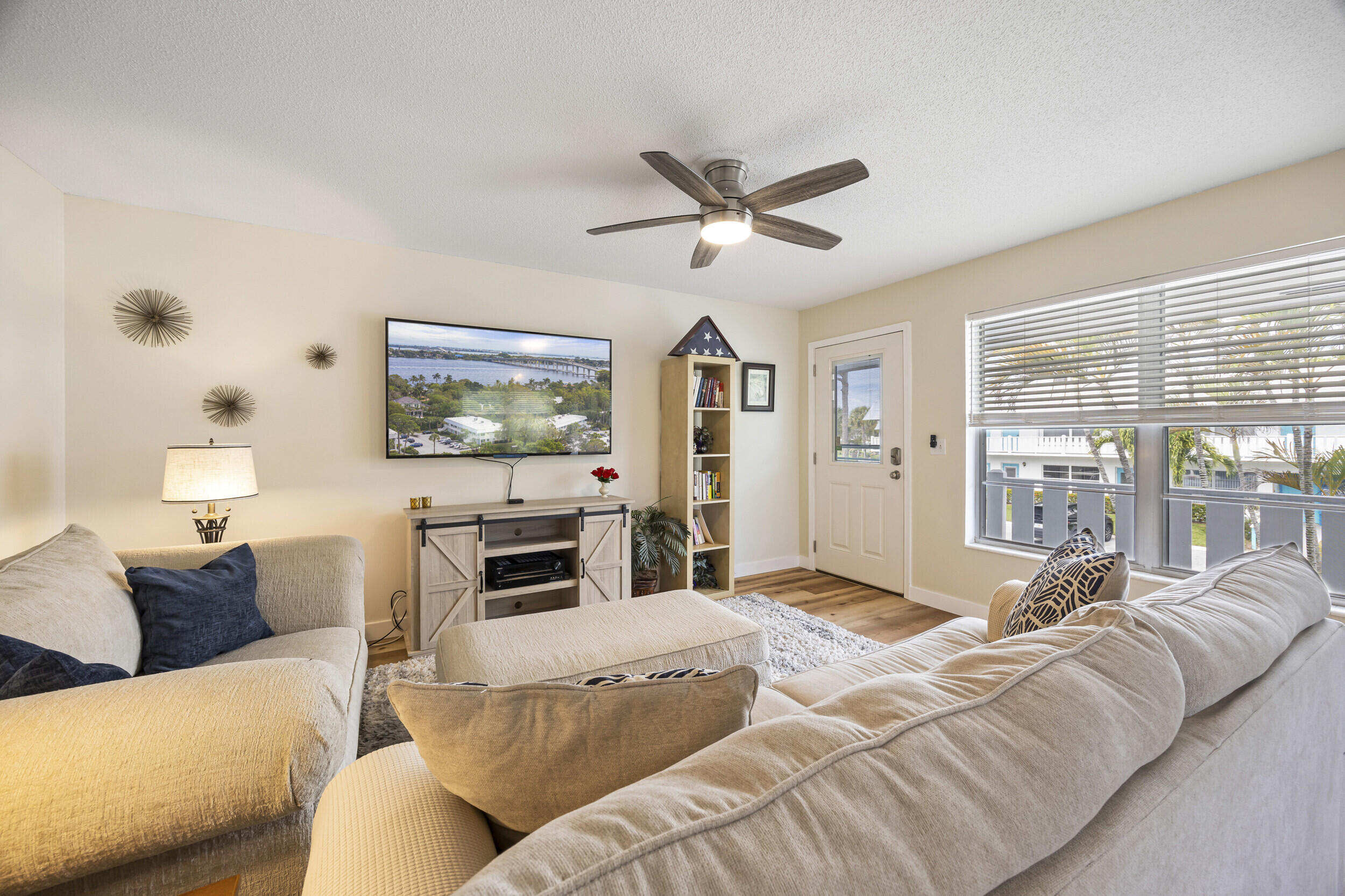 2929 Southeast Ocean Boulevard, Unit 10510 Stuart, FL 34996 - Photo 3 of 37 a bedroom with a large bed and a flat screen tv