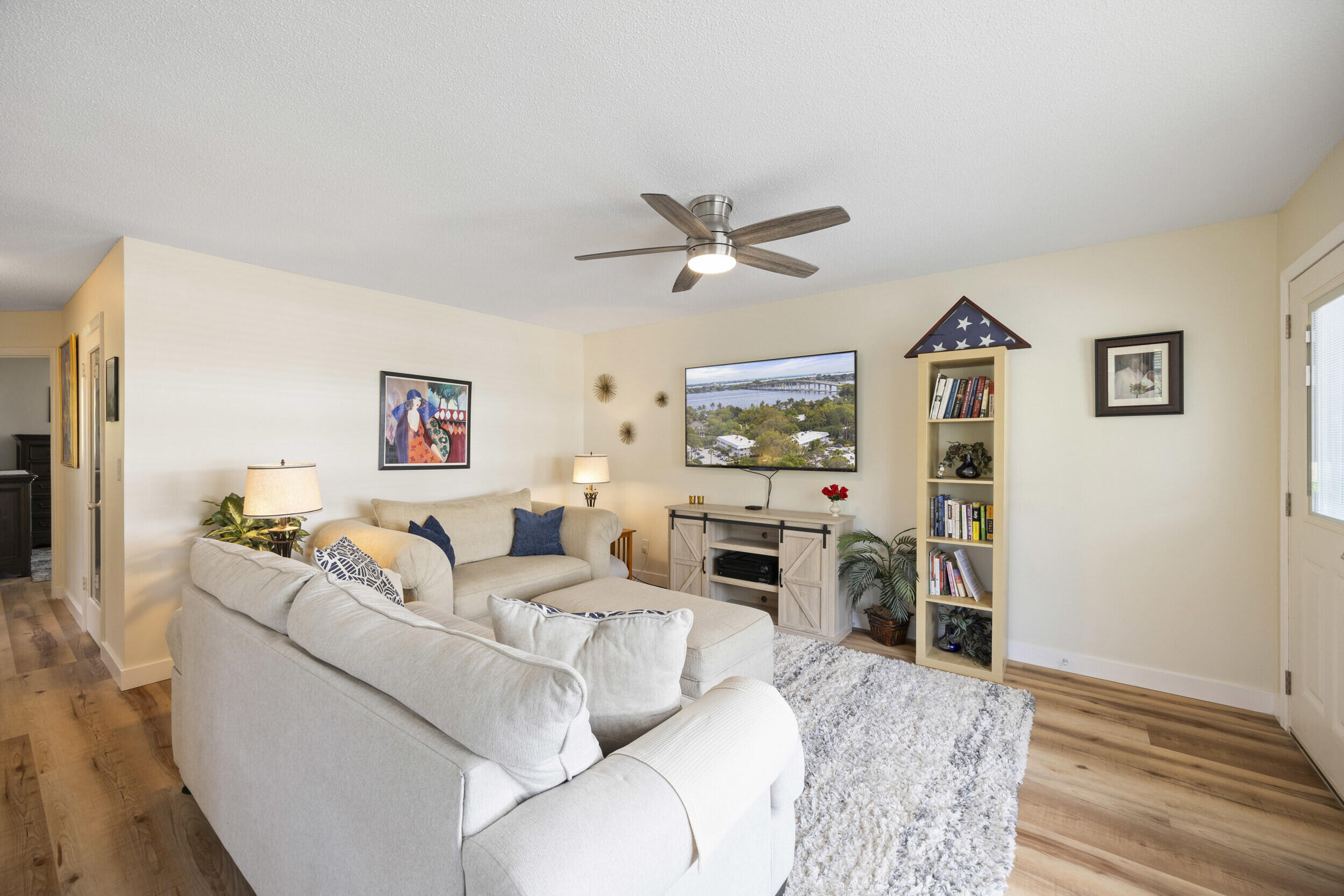 2929 Southeast Ocean Boulevard, Unit 10510 Stuart, FL 34996 - Photo 4 of 37 a living room with furniture and a wooden floor