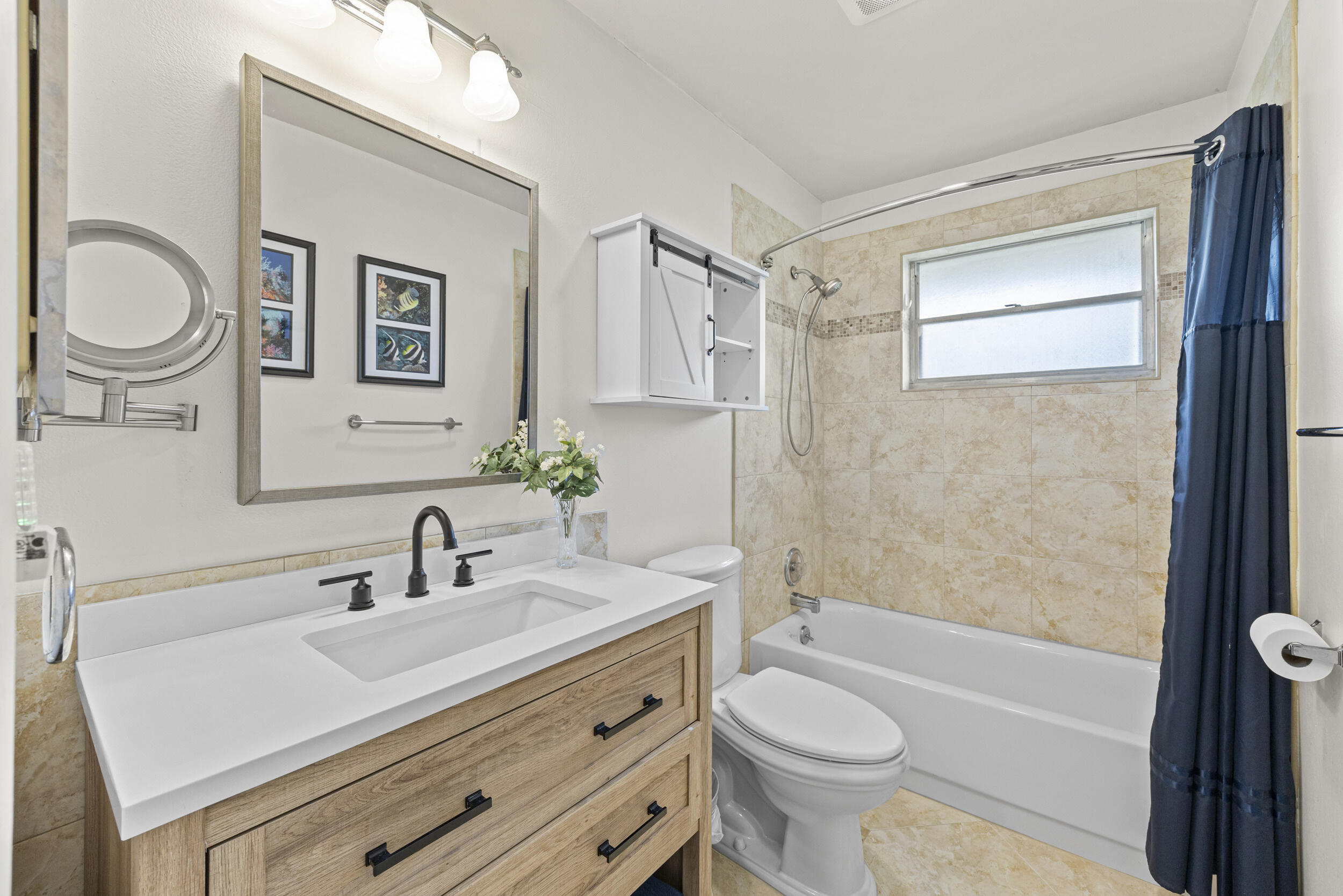 2929 Southeast Ocean Boulevard, Unit 10510 Stuart, FL 34996 - Photo 9 of 37 a bathroom with a sink a toilet and a mirror
