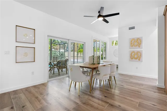 a view of a dining room with furniture window and wooden floor