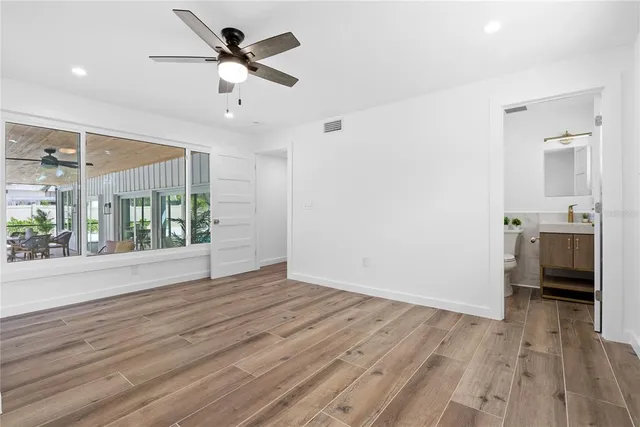 wooden floor in an empty room with a window