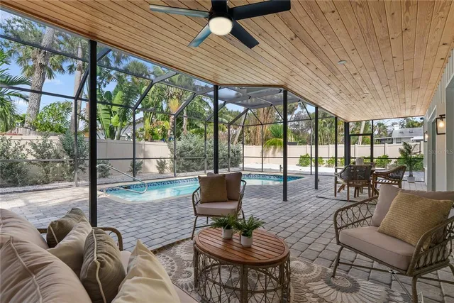 a living room with furniture and a floor to ceiling window