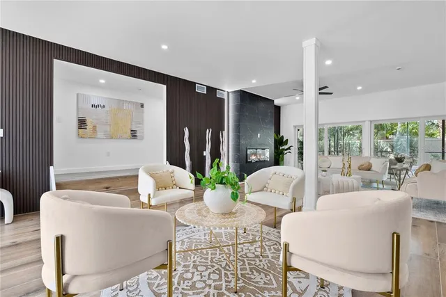 a living room with fireplace furniture and a large window