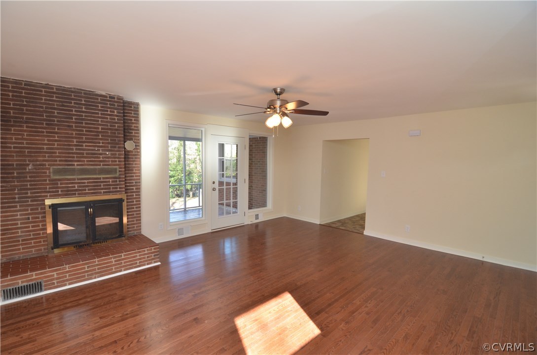 3308 Osborne Road Chester, VA 23831 - Photo 4 of 26 an empty room with wooden floor and fireplace