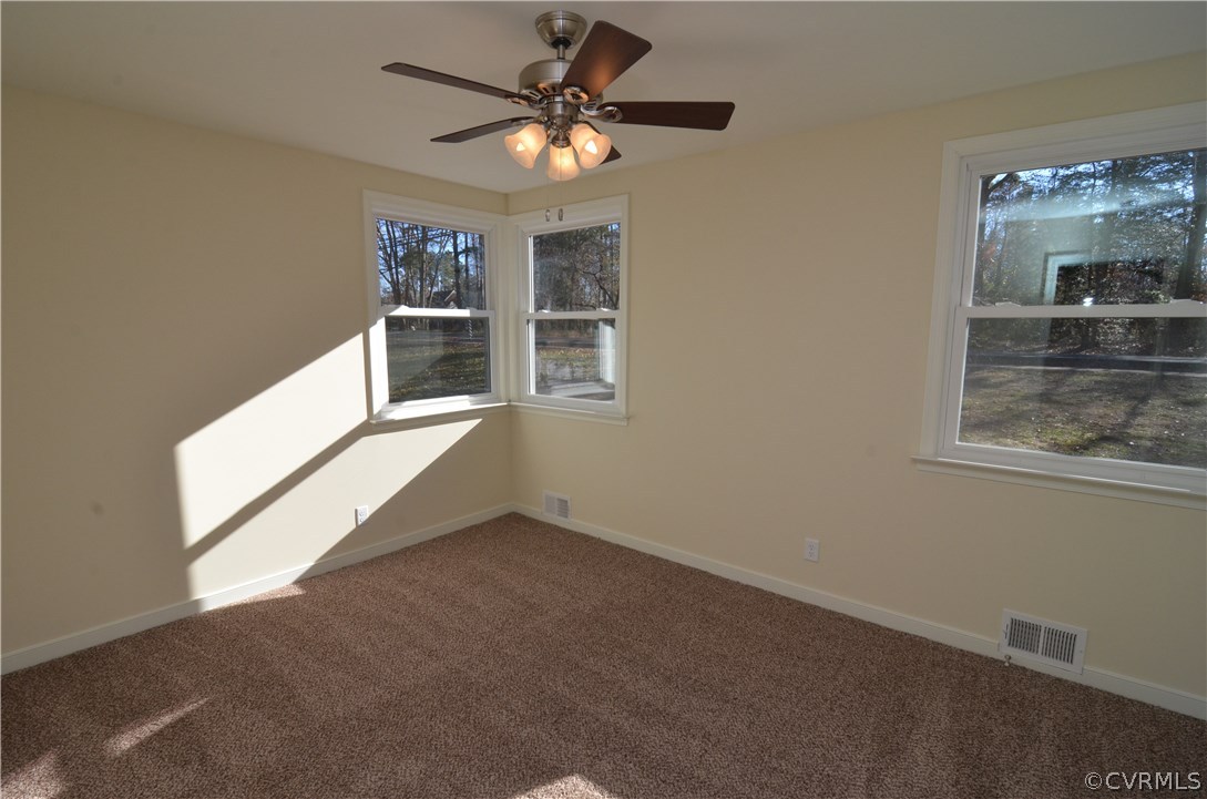3308 Osborne Road Chester, VA 23831 - Photo 6 of 26 an empty room with windows and ceiling fan