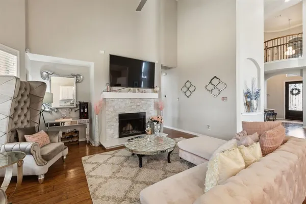 a living room with furniture a flat screen tv and a fireplace