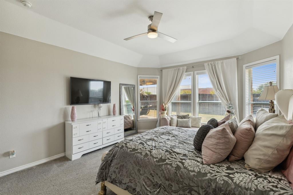 260 Dave Trail Prosper, TX 75078 - Photo 23 of 39 a bedroom with a large bed and a flat screen tv