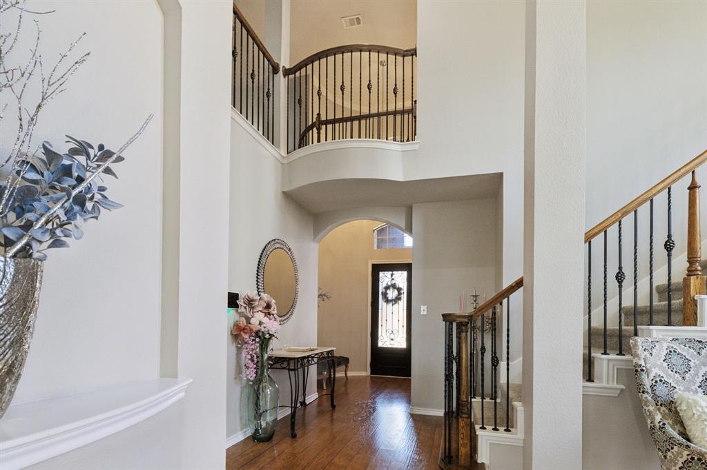 260 Dave Trail Prosper, TX 75078 - Photo 3 of 39 a view of staircase with lots of frames on wall clock and a potted plant