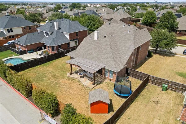 an aerial view of a house with swimming pool and outdoor space