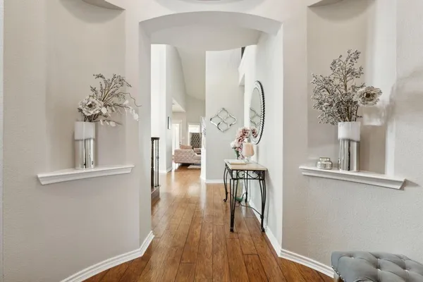 a view of a room with wooden floor and a chandelier
