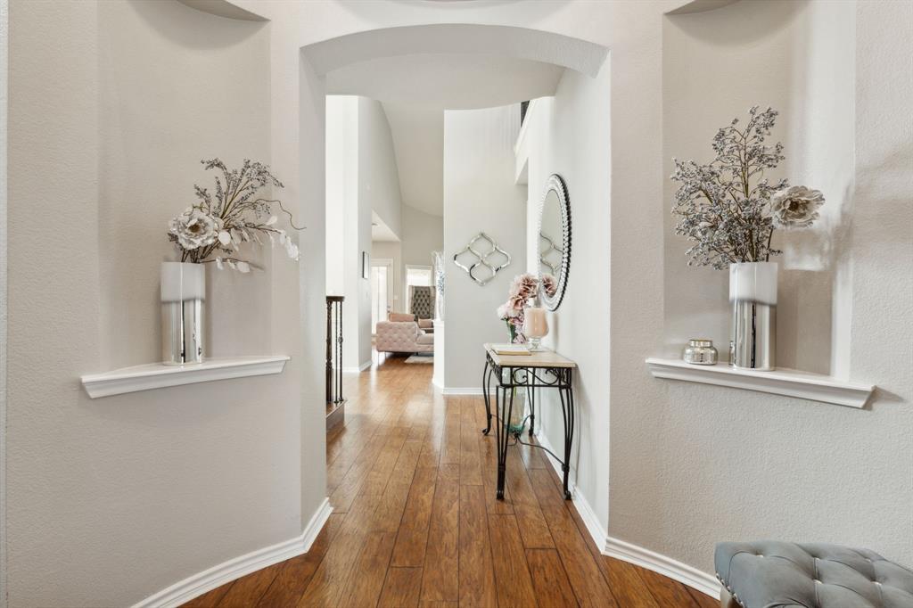 260 Dave Trail Prosper, TX 75078 - Photo 4 of 39 a view of a room with wooden floor and a chandelier
